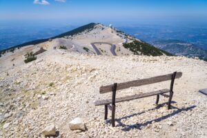 Bench in a scenic spot with a view of the mountains and blue sky. Mont Ventoux, France.